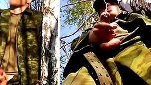 Russian soldier with a big dick on a military specification in the forest shoots sperm from his penis at opponents
