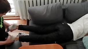 Young guy pays out his bills with his feet