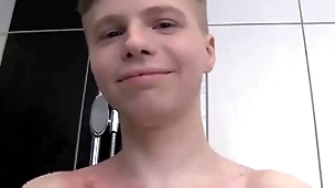 Cute soapy young man alone in a shower