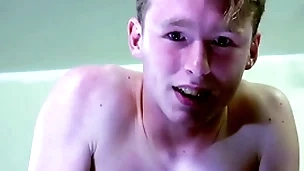 A straight blond boy is near tears while being spanked